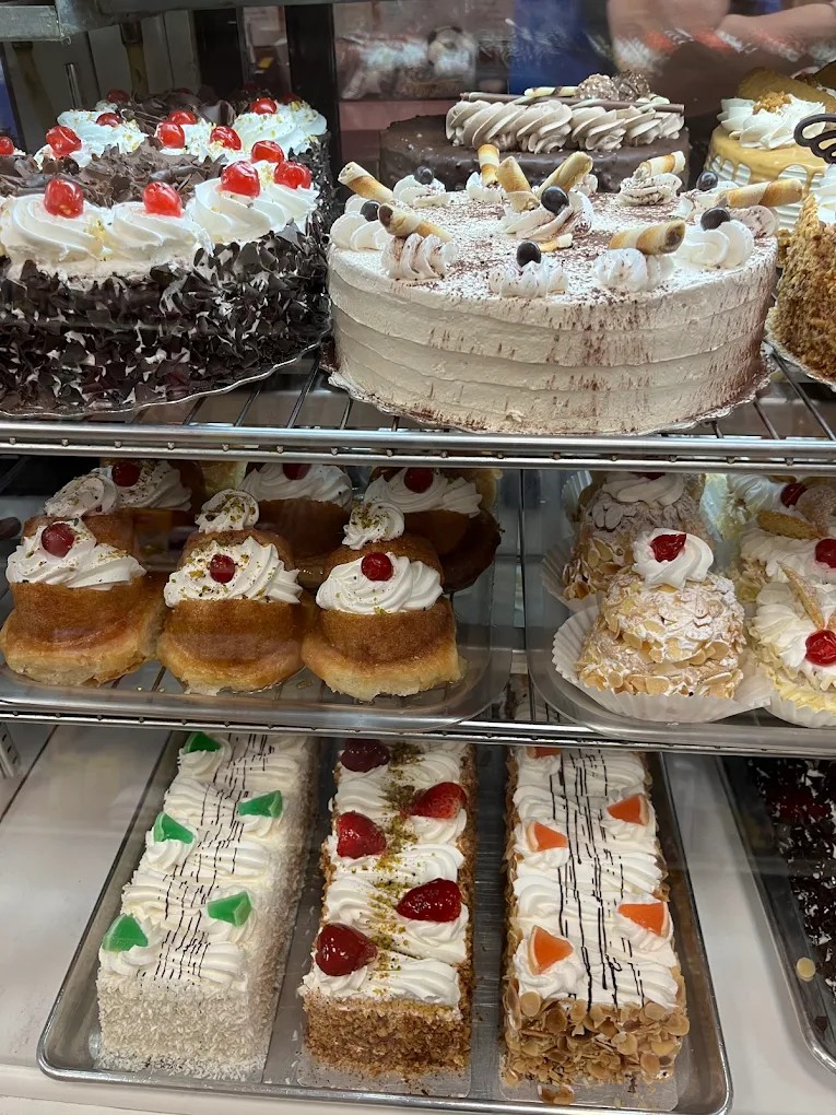 Assorted whole cakes and tortes in the bakery display case